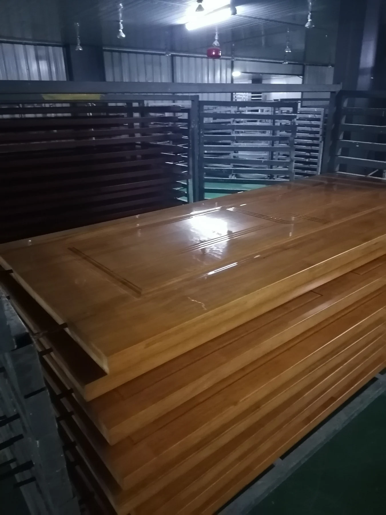 Finished wooden door panels stacked in a production workshop