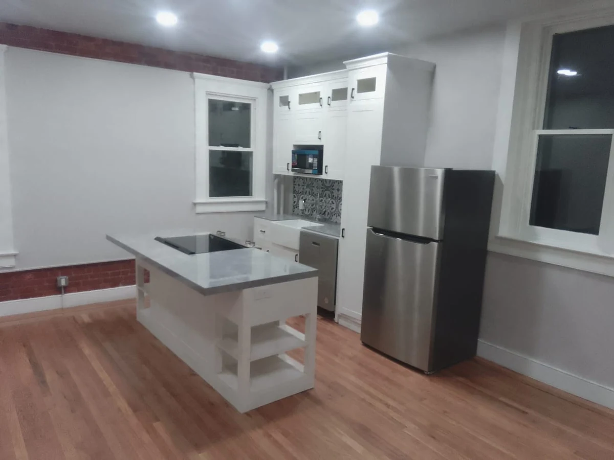 George Group-supplied white kitchen cabinetry and island in a customer's residential installation