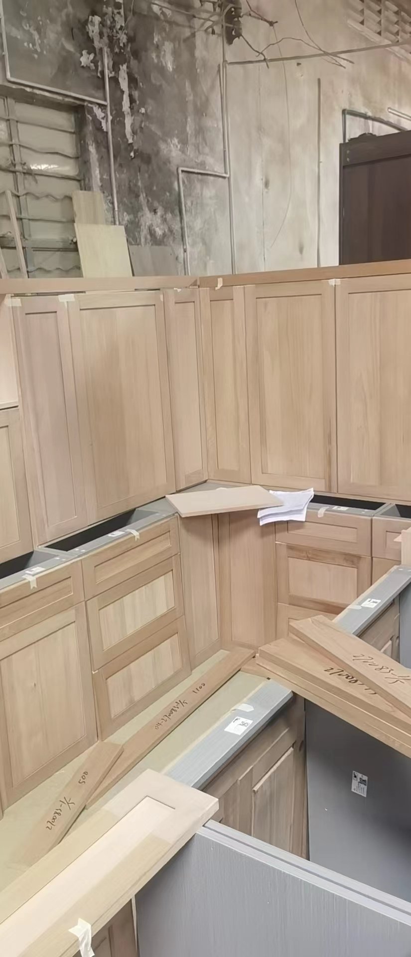 Light wood cabinets assembled in a factory workshop with inner cabinet bodies exposed